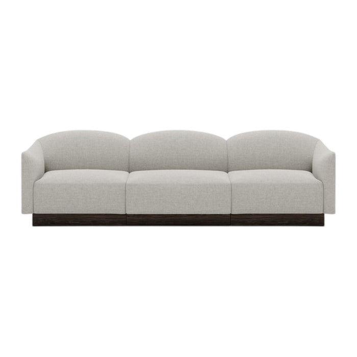 Light gray upholstered sofa with rounded cushions and a dark wood base, featuring a minimalist design.
