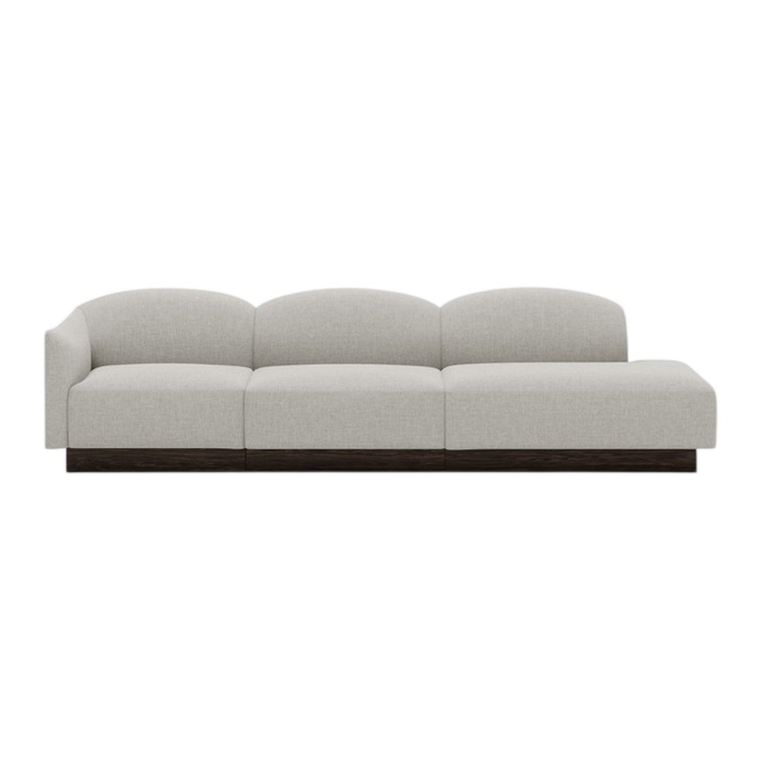 Light gray, plush sofa with smooth, curved lines and a dark wood base, ideal for modern interiors.