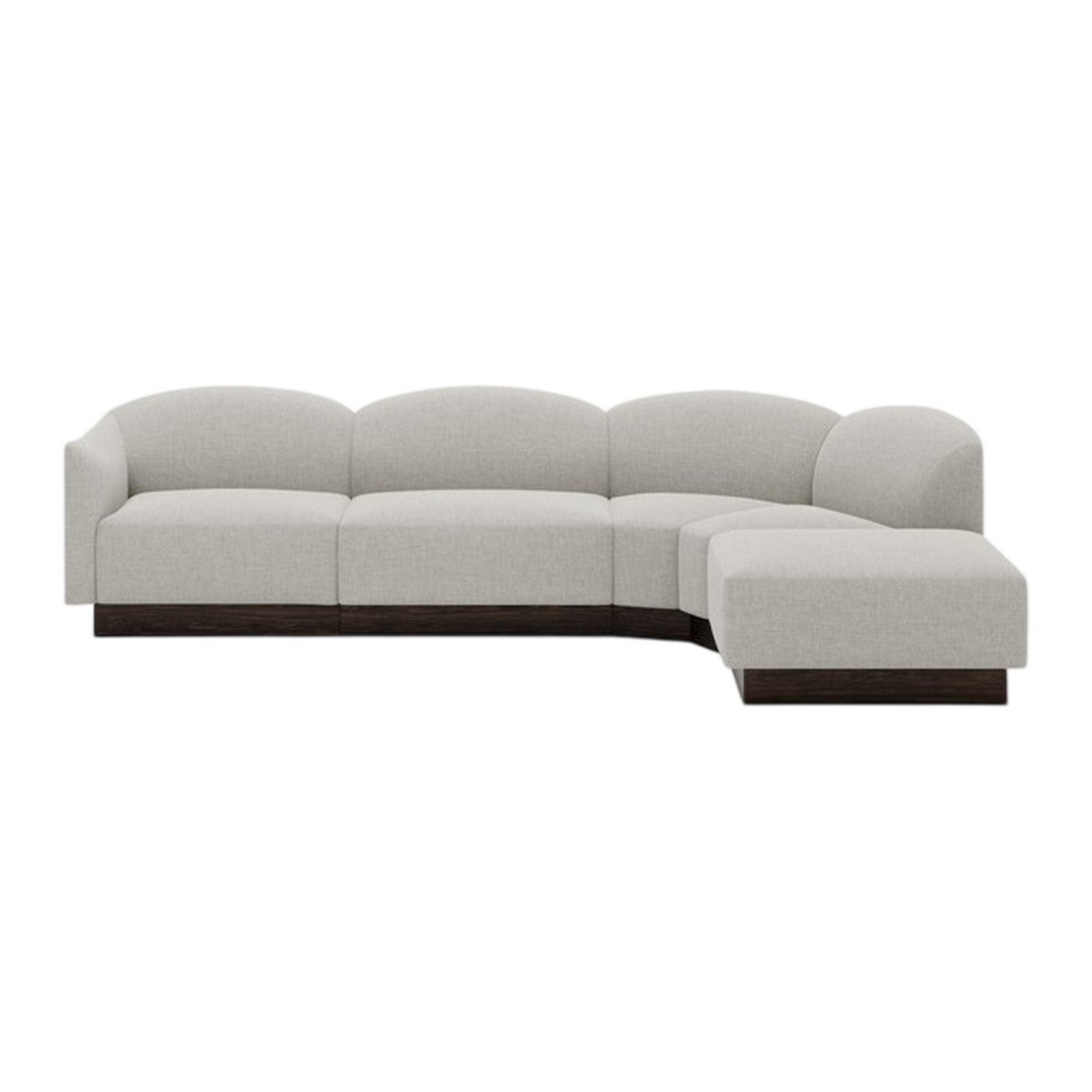 Light gray sectional sofa with a smooth, curved design and dark wood base, perfect for modern living spaces.