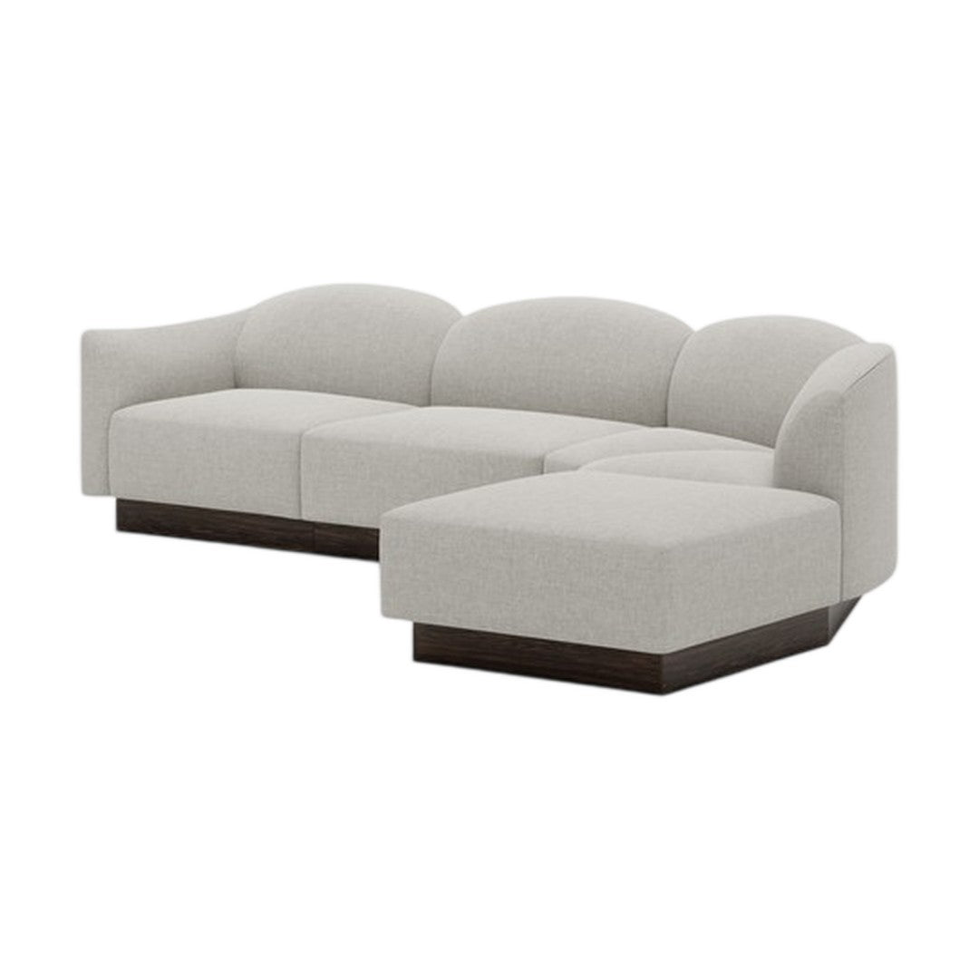 Light gray fabric sectional sofa with rounded back and dark wood base, featuring a seamless, minimalist design.