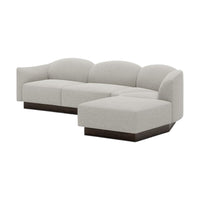 Light gray fabric sectional sofa with rounded back and dark wood base, featuring a seamless, minimalist design.