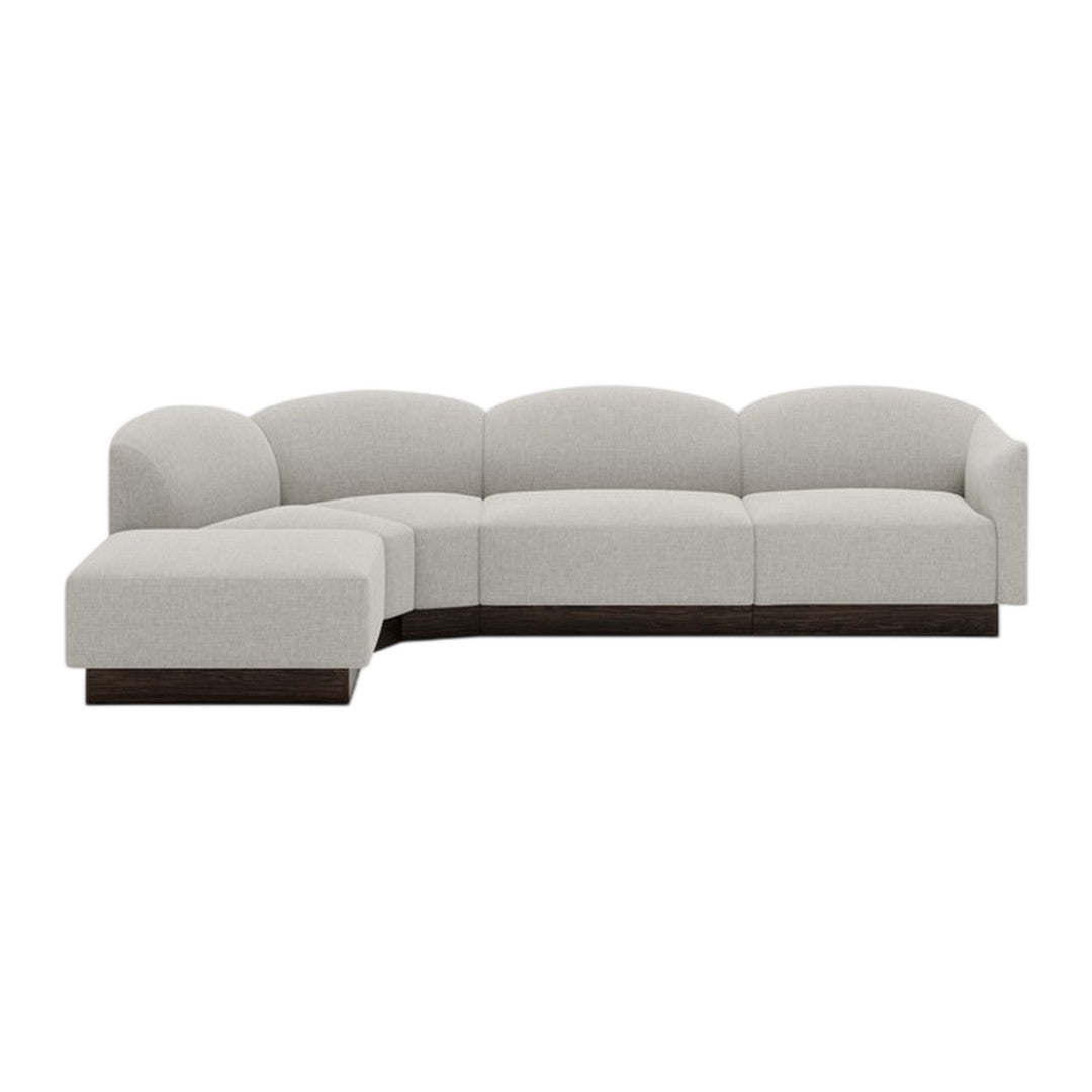 Light gray curved sectional sofa with smooth fabric and dark wood base, ideal for modern living spaces.