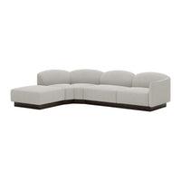 Light gray sectional sofa with smooth curves and a sleek, dark wood base for a modern aesthetic.
