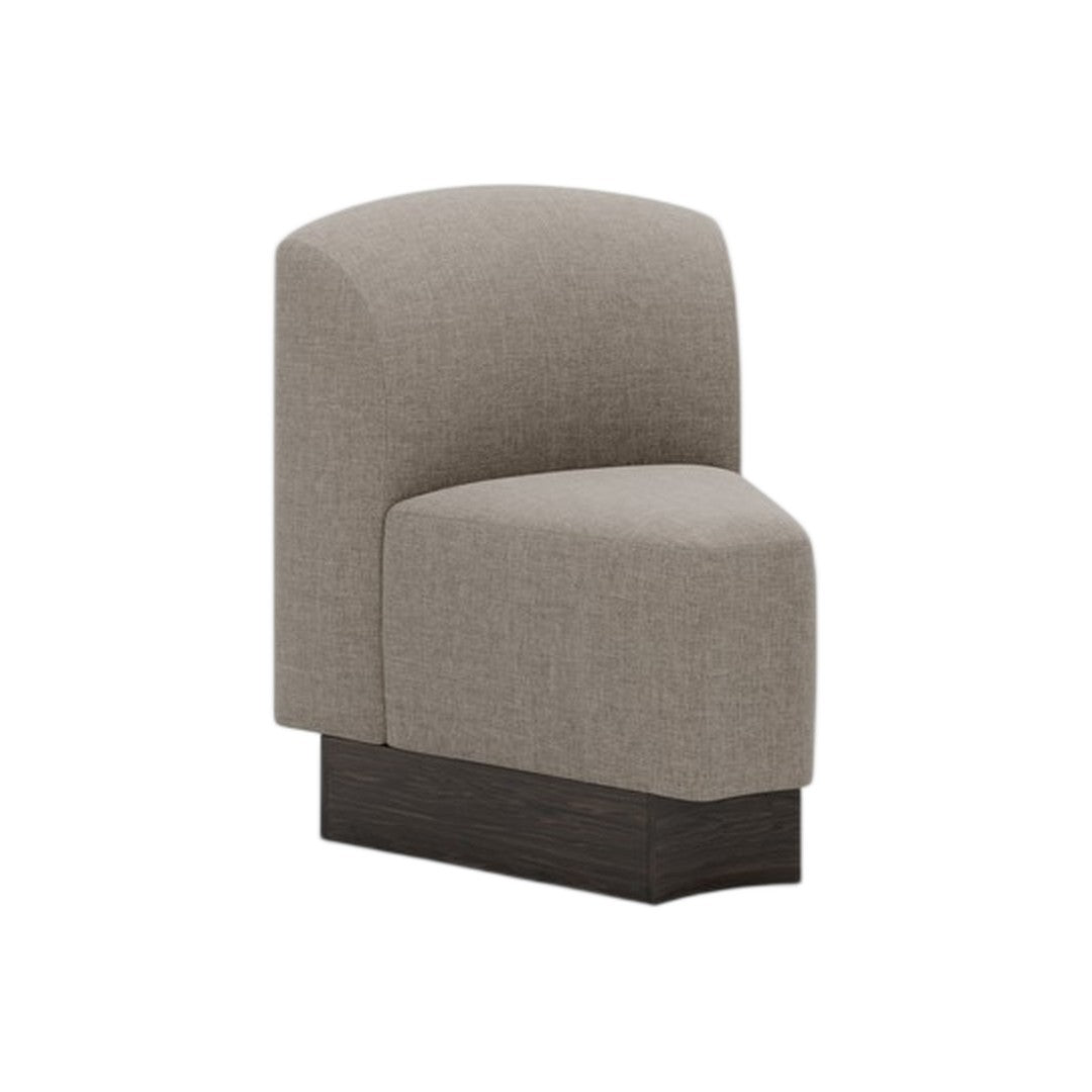 Contemporary accent chair in soft gray upholstery with smooth, curved lines and a dark wood base. Ideal for modern interiors.