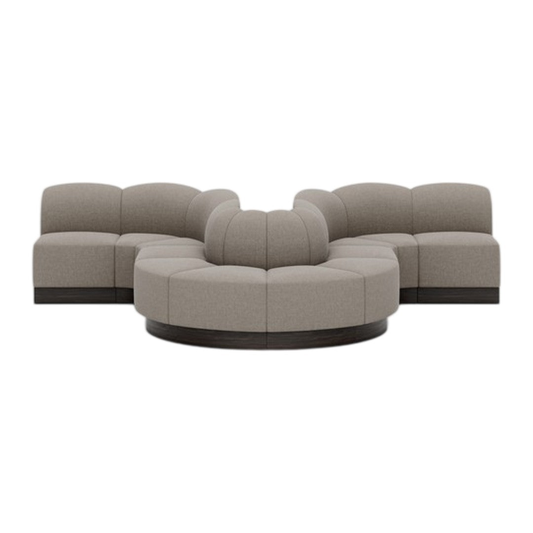 Modern curved sectional sofa in light taupe upholstery with subtle texture and dark wood accents. Perfect for cozy spaces.
