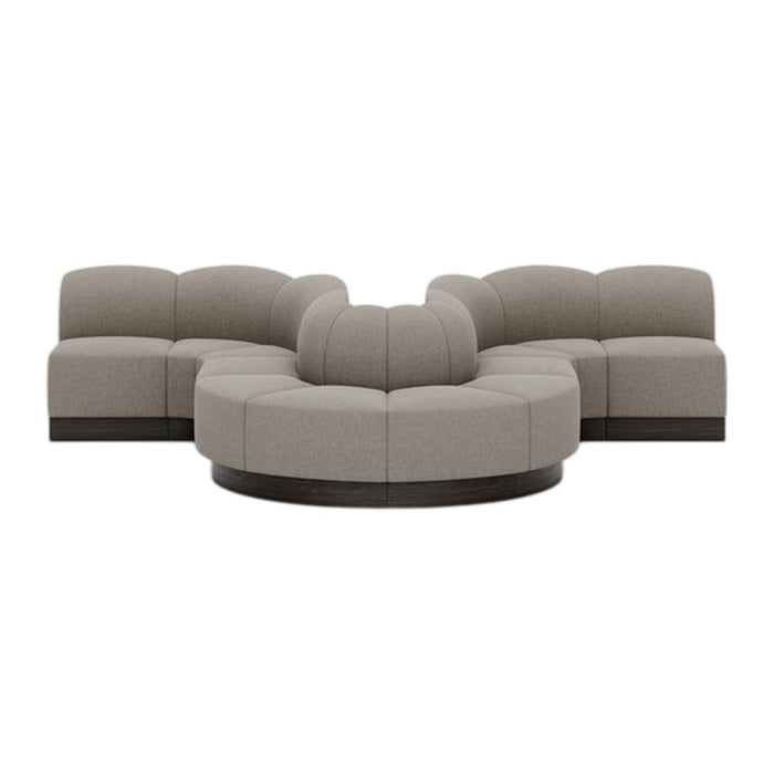 Modern curved sectional sofa in light taupe upholstery with subtle texture and dark wood accents. Perfect for cozy spaces.