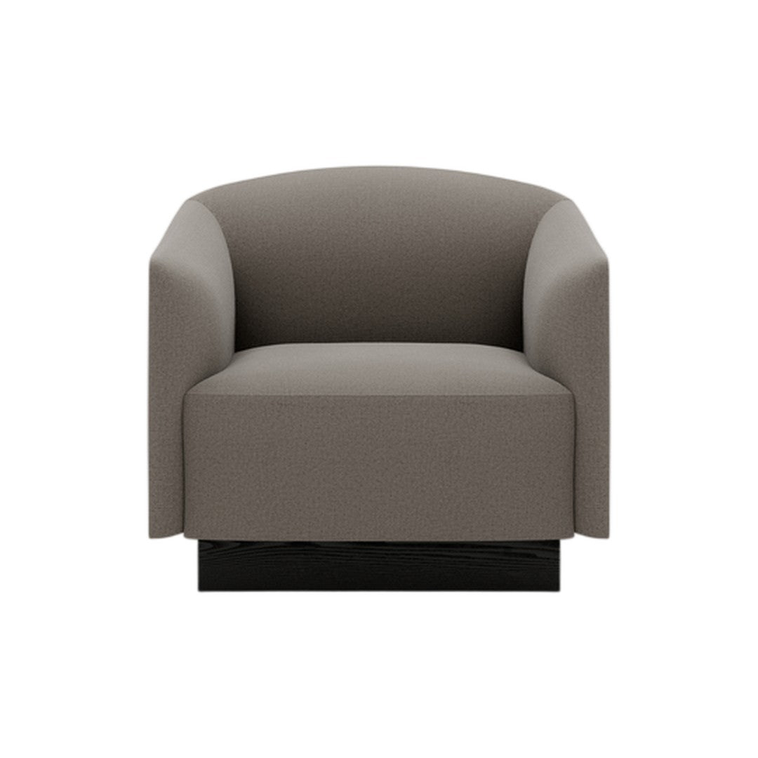 Gray upholstered armchair with a minimalist design and smooth, rounded edges. Black base adds modern touch.