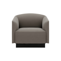 Gray upholstered armchair with a minimalist design and smooth, rounded edges. Black base adds modern touch.