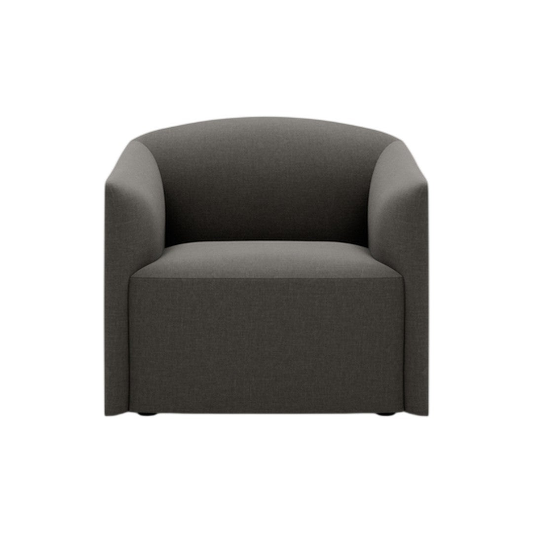 Elegant dark gray upholstered armchair with a minimalist, curved design for modern decor.