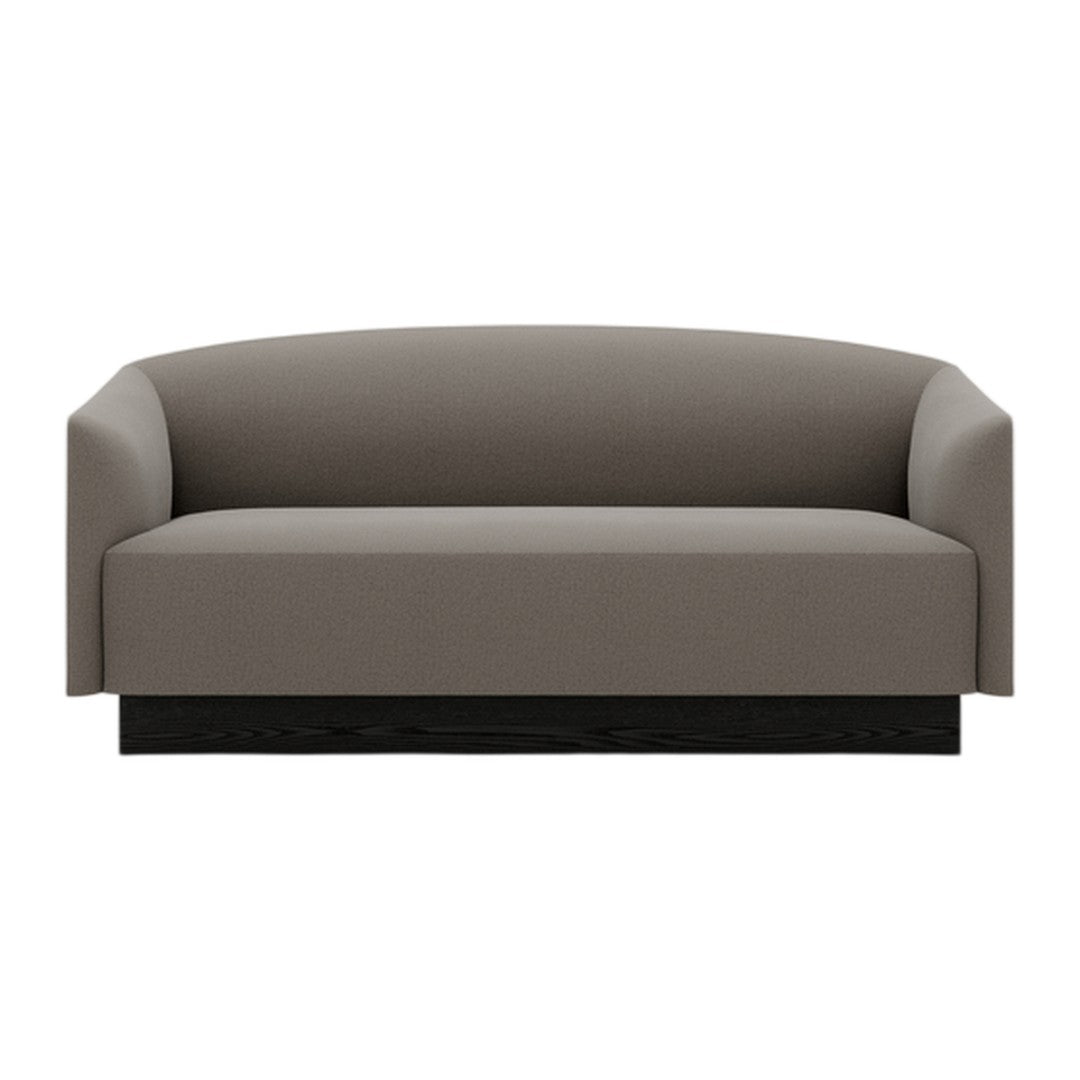 Gray upholstered sofa with a smooth, minimalist design and a sleek black base. Perfect for modern interiors.