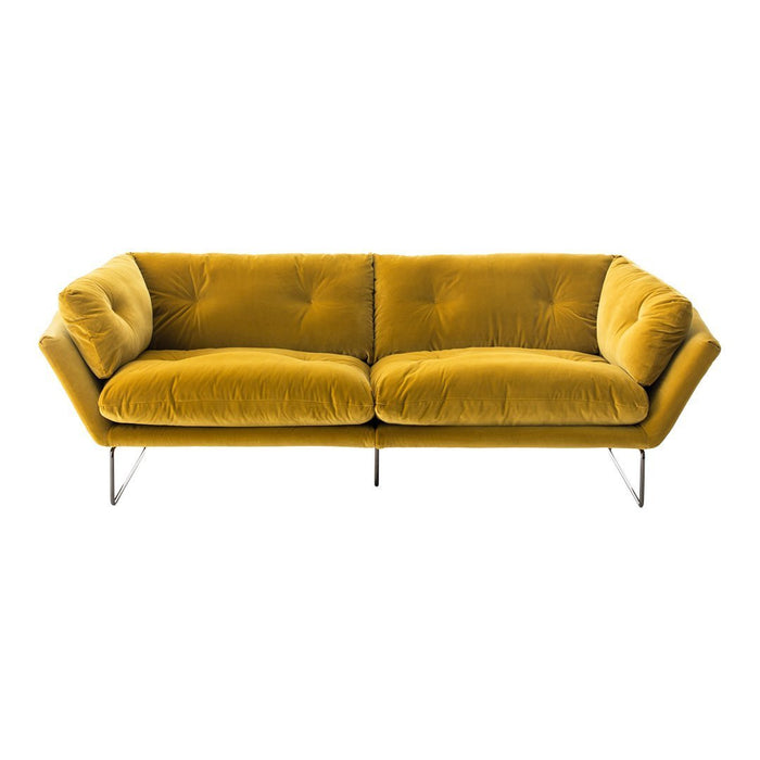 Velvet mustard yellow sofa with tufted design and sleek metal legs, perfect for modern decor.