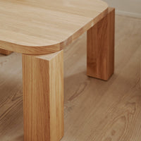 Light natural wood table with smooth, rounded edges and textured, warm oak grain pattern. Ideal for modern interiors.
