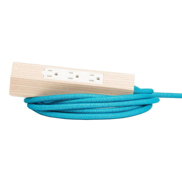 "Turquoise braided power cord with a wooden outlet, featuring a sleek, modern design."