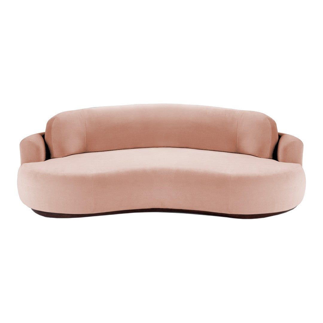 Curvy blush pink sofa with soft, smooth velvet upholstery, perfect for stylish indoor decor.