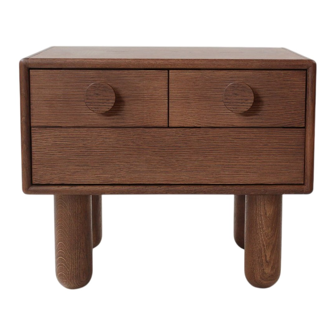 Wooden bedside table in rich brown with smooth finish, featuring two round drawer knobs and round legs.