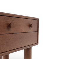 Brown wooden dresser with a smooth finish and minimalist design, featuring two drawers and round knobs.