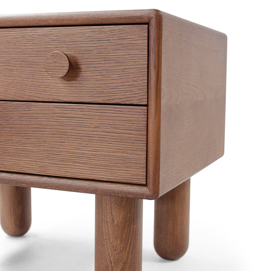 Wooden nightstand featuring a rich brown finish and a textured grain pattern, with rounded legs and a single drawer.