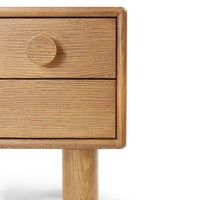 Light oak nightstand with a natural wood grain pattern and a round wooden knob. Simplistic and modern design.