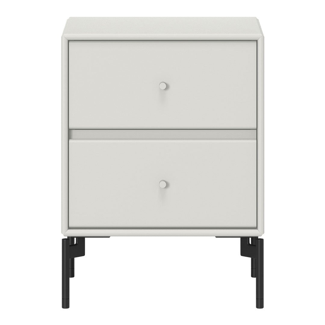 White nightstand with a sleek design, featuring smooth surfaces and minimalist black legs. Ideal for modern decor.