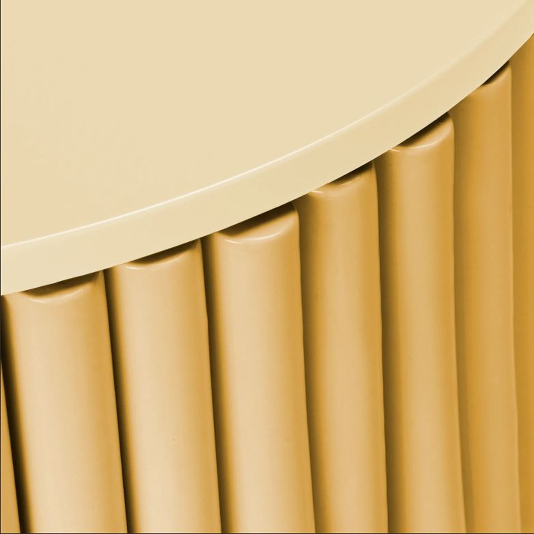Round table with a smooth, light yellow top and textured, fluted yellow base pattern.