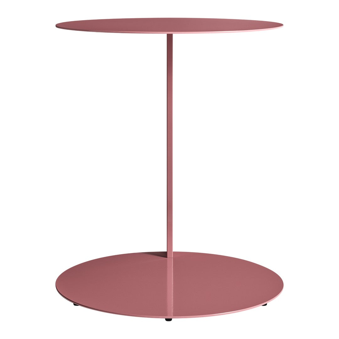 Round side table in soft pink color with a sleek, minimalist design and smooth surface. Ideal for modern decor.