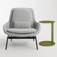 Gray upholstered armchair with a black metal base, paired with a round olive green side table. Modern minimalist design.