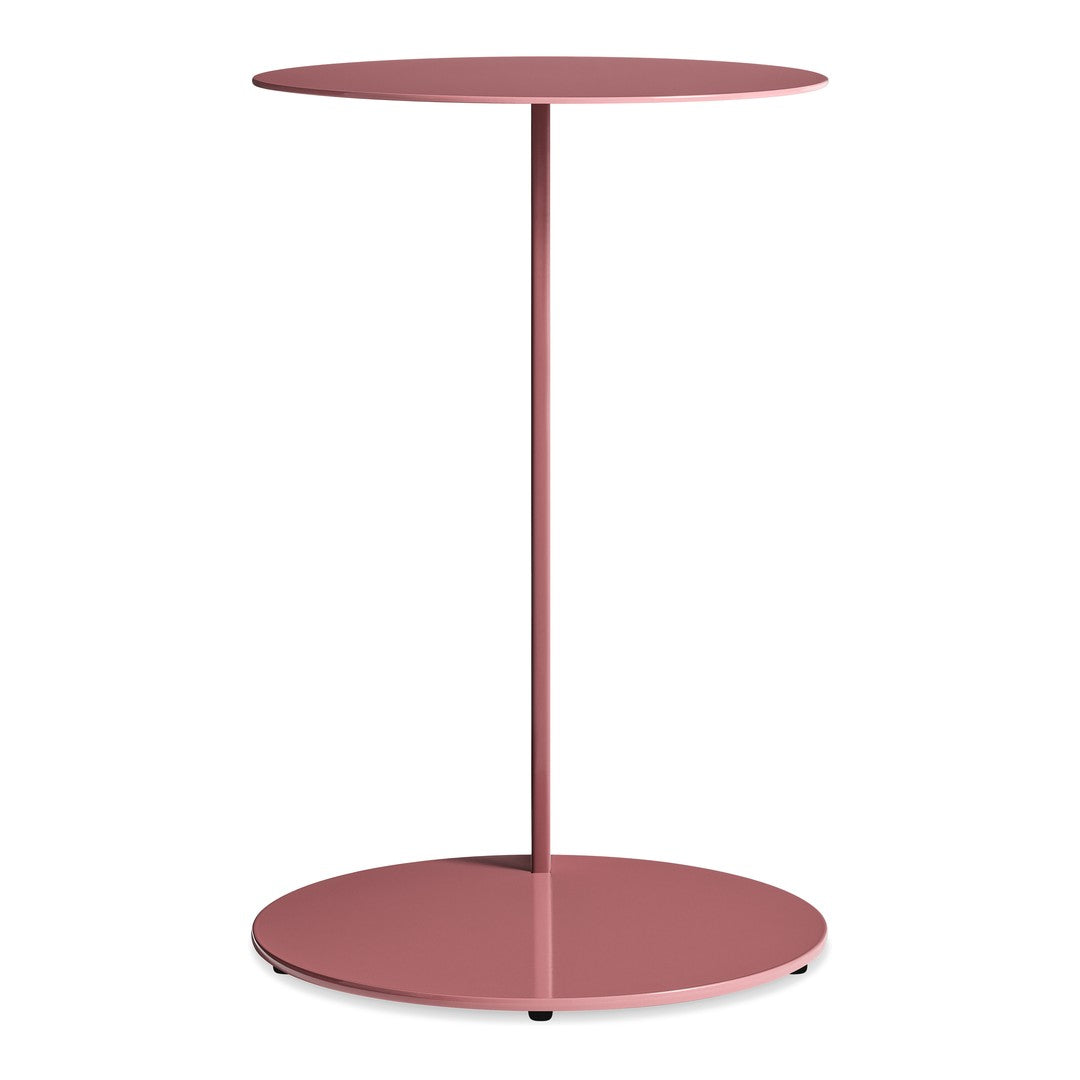 Modern round side table in soft pink with a sleek, minimalistic design and circular base. Perfect for any decor.