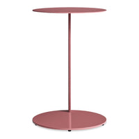 Modern round side table in soft pink with a sleek, minimalistic design and circular base. Perfect for any decor.