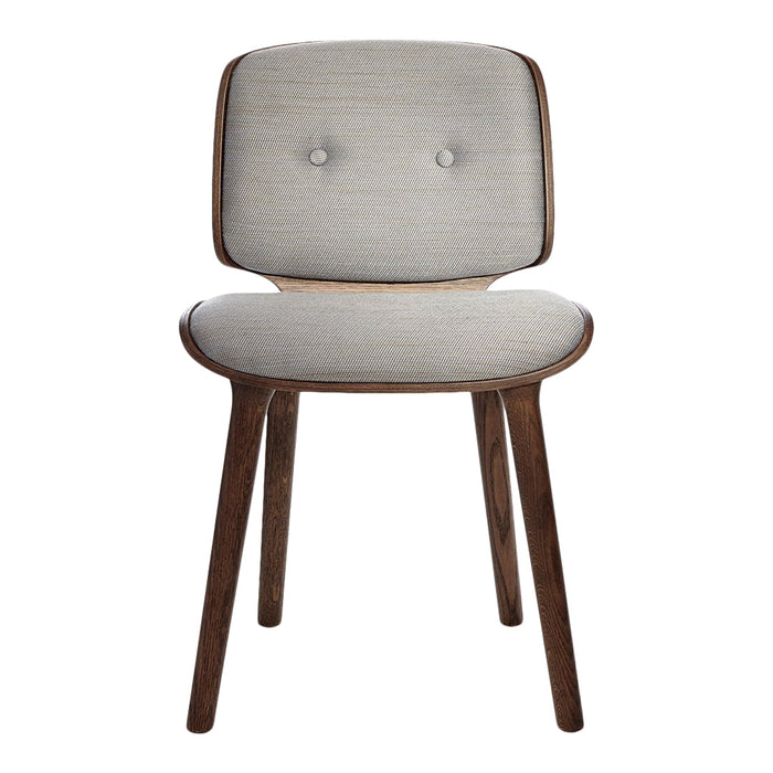 Light gray upholstered chair with button detailing and dark wood legs, featuring a minimalist design.