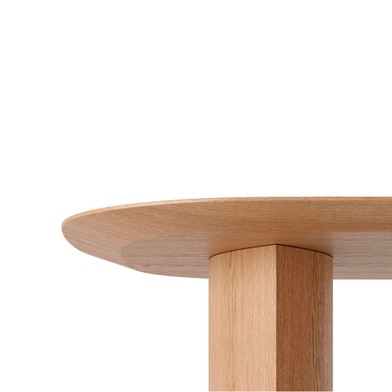 Natural wood table with a smooth light oak finish and clean, minimalist design against a white background.