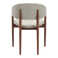 Minimalist gray velvet chair with a smooth, rounded back and sleek walnut wood legs. Perfect for modern decor.