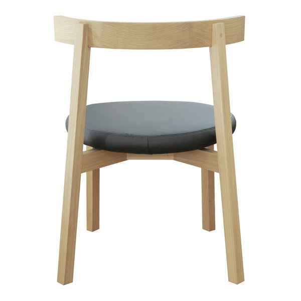 Light wood frame with a round black leather seat, showcasing a modern and minimalist design.