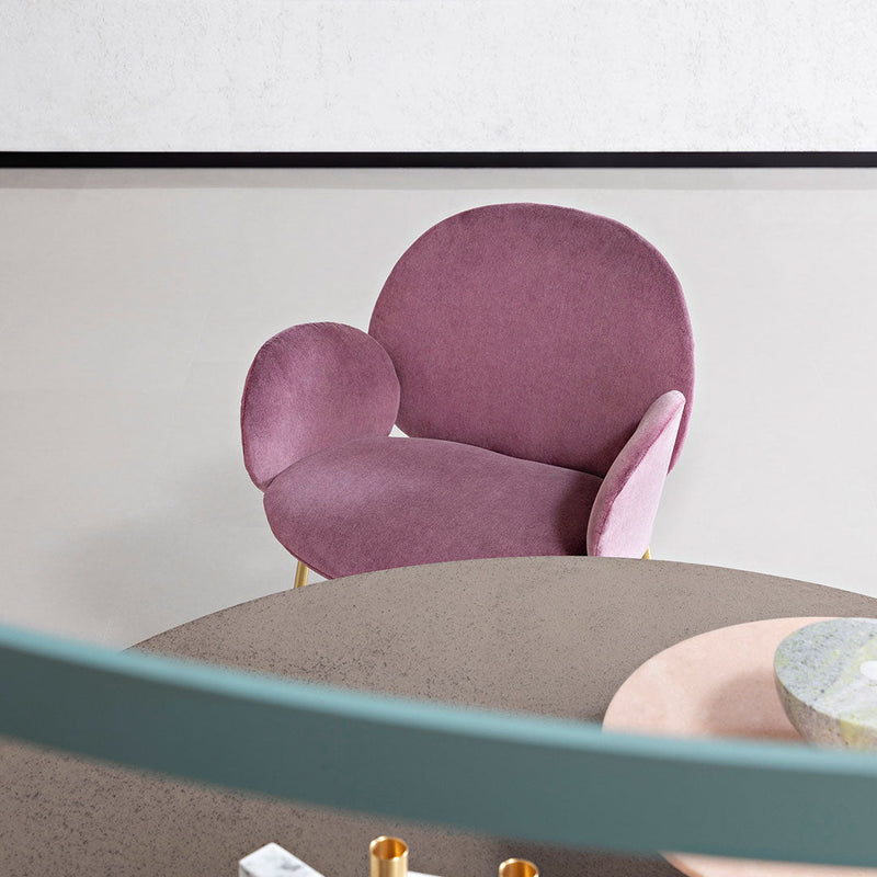 Plush pink armchair with unique rounded shapes and soft textures, set against a minimalist backdrop.