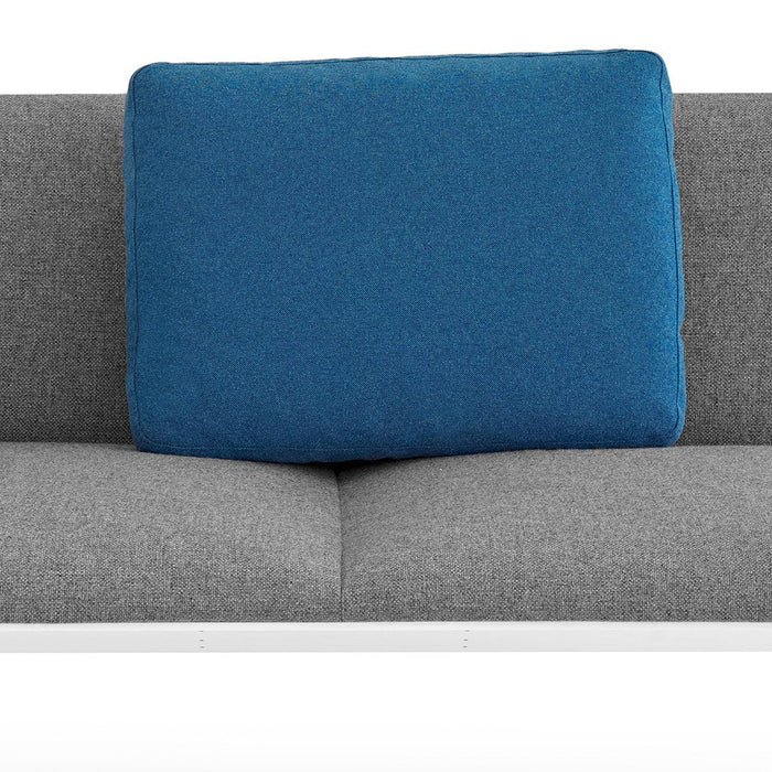 Gray couch with a bold blue square pillow, showcasing a modern and stylish color contrast. Perfect for contemporary decor.