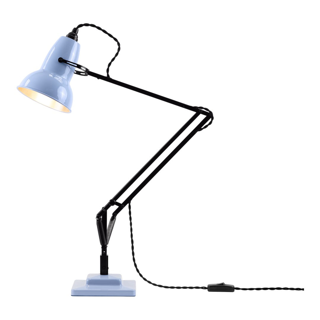 Blue metal lamp with black arms and a square base, featuring a braided black and white power cord.