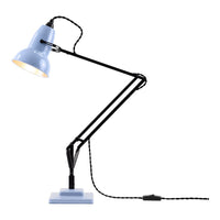 Blue metal lamp with black arms and a square base, featuring a braided black and white power cord.
