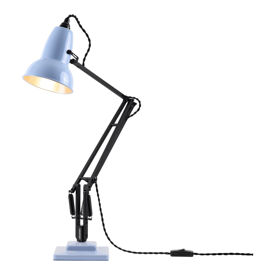 Blue desk lamp with a sleek black arm and patterned cord, featuring a modern design and contrasting light shade.