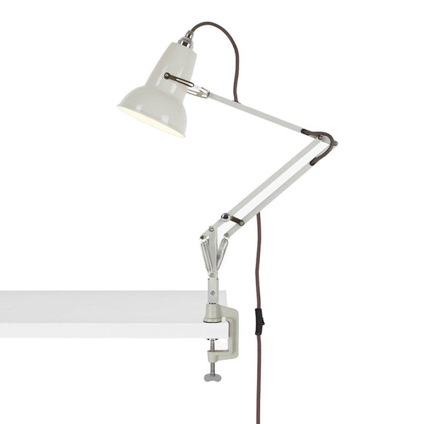 White adjustable desk lamp with a sleek, minimalist design and a brown cord, perfect for modern decor.