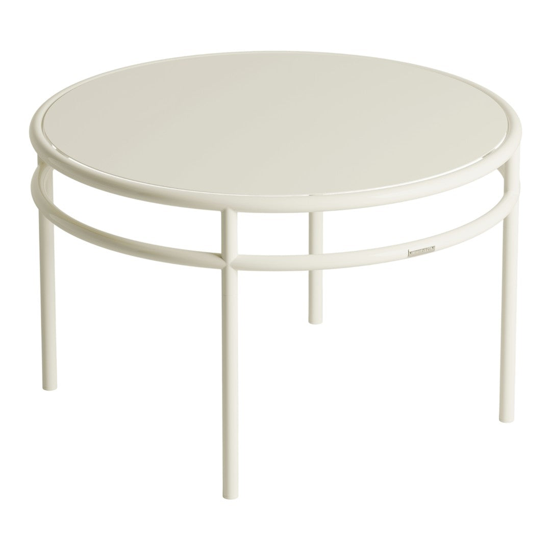 Round white coffee table with a smooth surface and minimalist design, featuring a sleek, solid frame.
