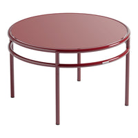 Round, glossy burgundy coffee table with minimalist design and sleek metal frame. Perfect for modern decor.