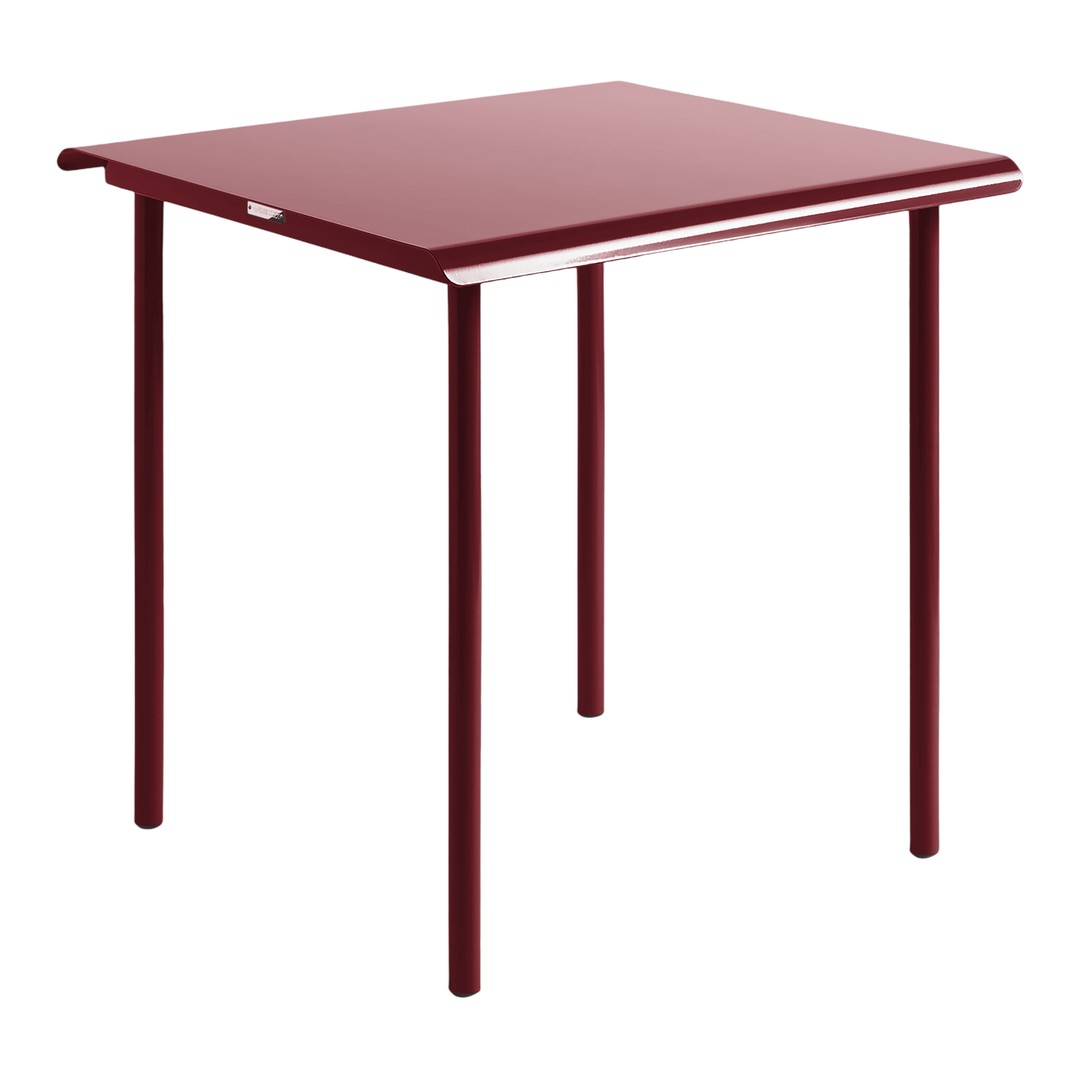 Red tabletop with sleek, smooth surface and contrasting white trim, supported by simple metal legs.