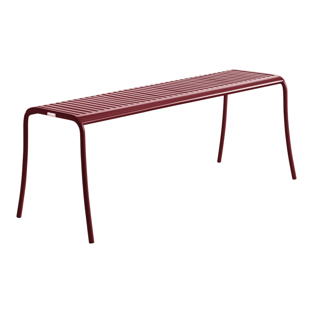 Red metal bench with a sleek, minimalistic design and slatted pattern. Ideal for modern outdoor spaces.