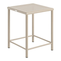 Beige metal side table with a textured, perforated top and sleek design, perfect for indoor and outdoor use.