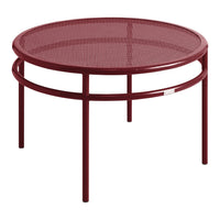 Round burgundy metal coffee table with a stylish perforated pattern and sleek, minimalistic design.