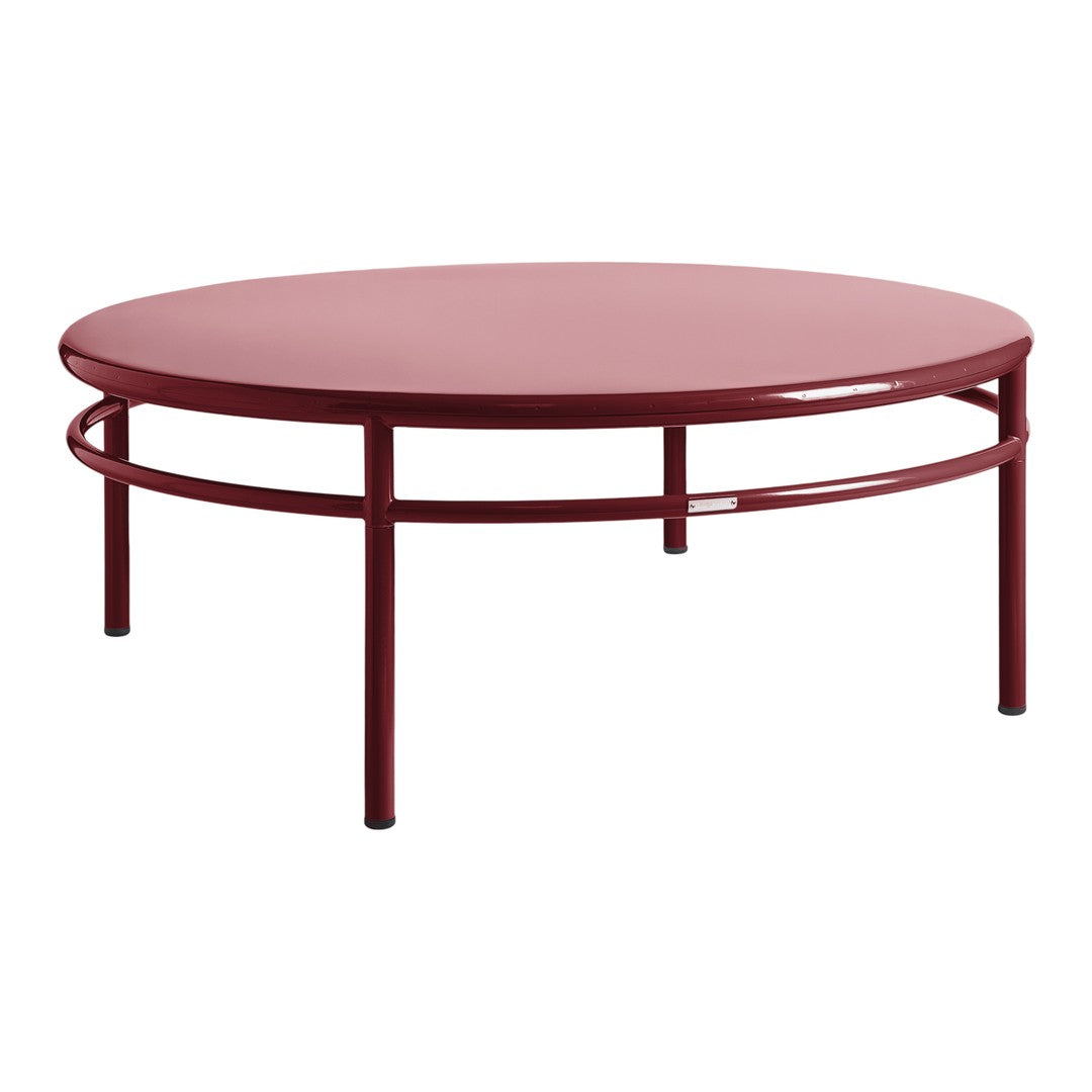 Round red coffee table with a sleek, modern design and minimalist structure. Ideal for contemporary spaces.