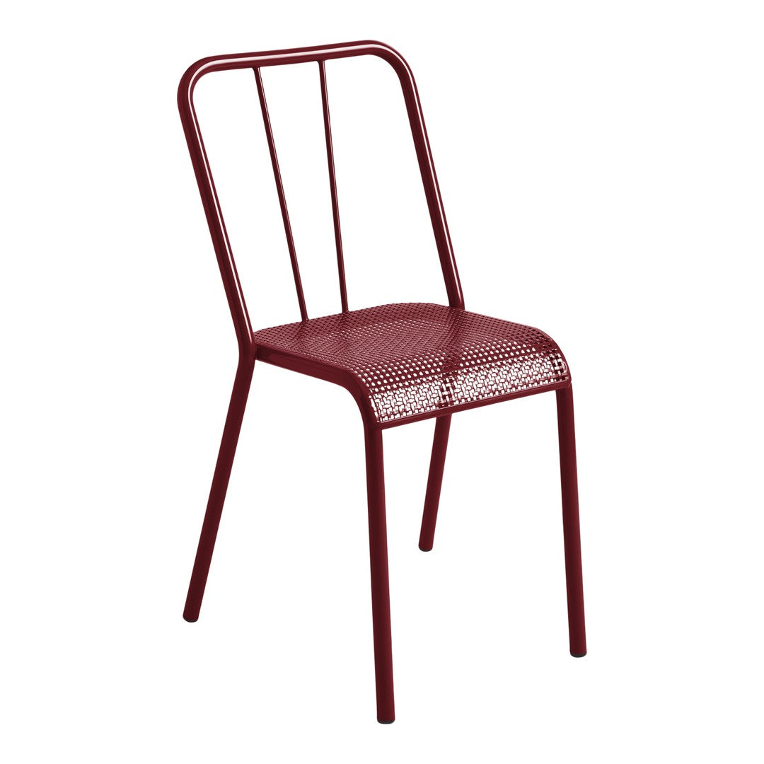 Red metal chair with a perforated seat and minimalist design, perfect for modern decor.