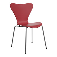 Red butterfly chair with smooth contours and sleek chrome legs, perfect for modern decor. 