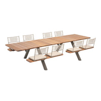 Elegant wooden dining table with beige cushioned seats and modern metal accent chairs in a sleek, minimalist design.