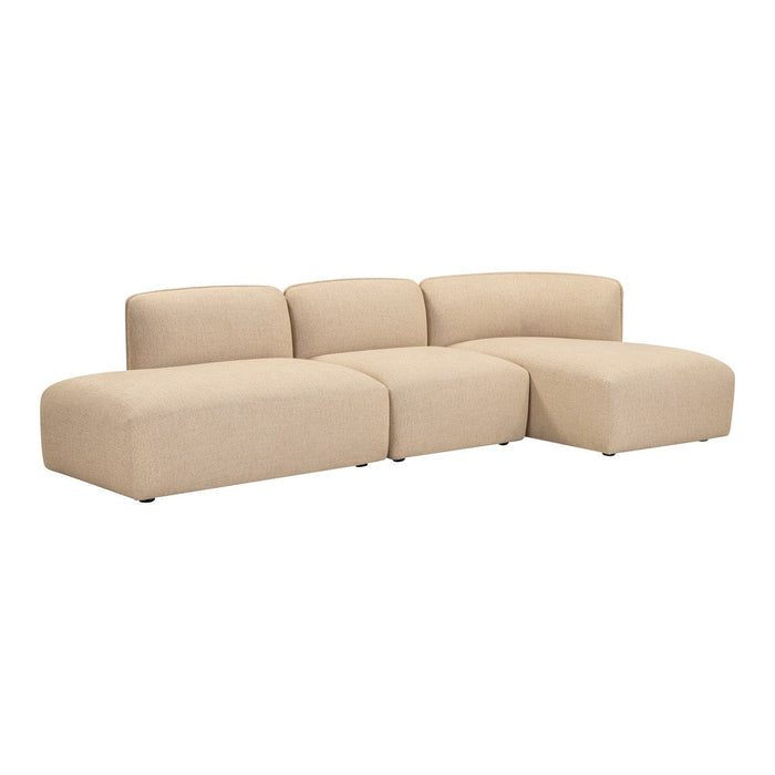 Beige sectional sofa with a smooth, minimalist design, featuring plush cushions and rounded shapes for a modern aesthetic.