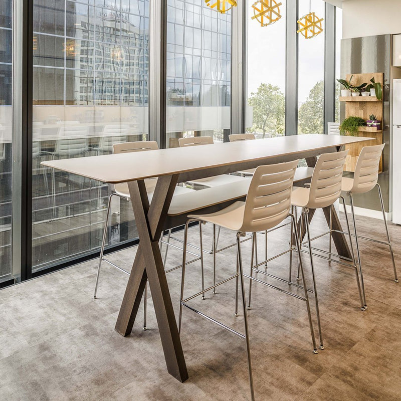 Minimalist white tabletop with natural wood legs, complemented by pale beige chairs on a soft gray carpet.
